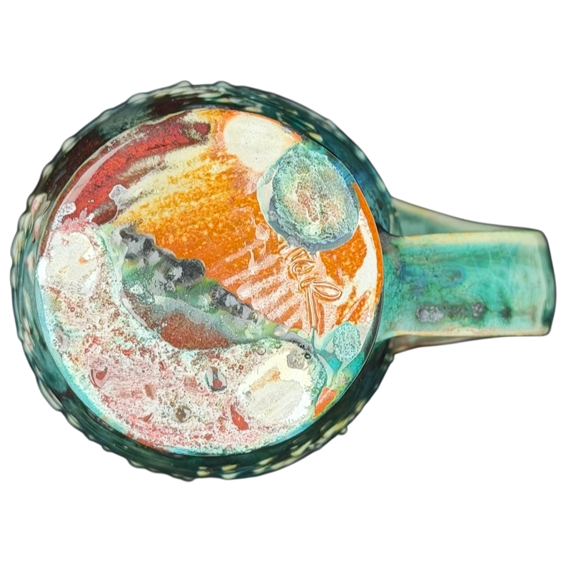 Artisan botanical pottery mug featuring vibrant colors and unique hand-painted designs