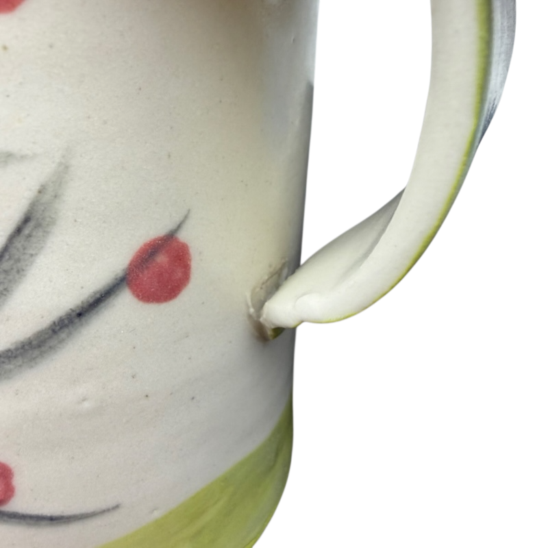 Artisan pottery mug with bird topper featuring floral designs and a comfortable handle