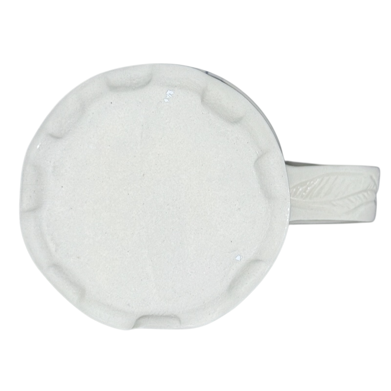 Vintage abstract blue lines pottery mug top view showing off white textured base and leaf handle