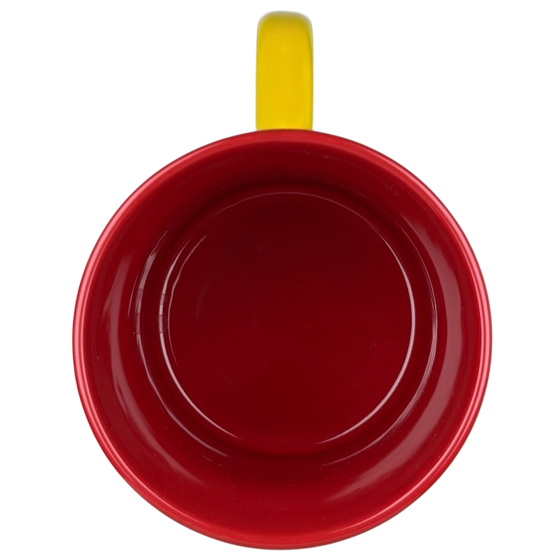 Top view of a red mug with a yellow handle featuring a Mickey Mouse Disneyland graphic font mug design