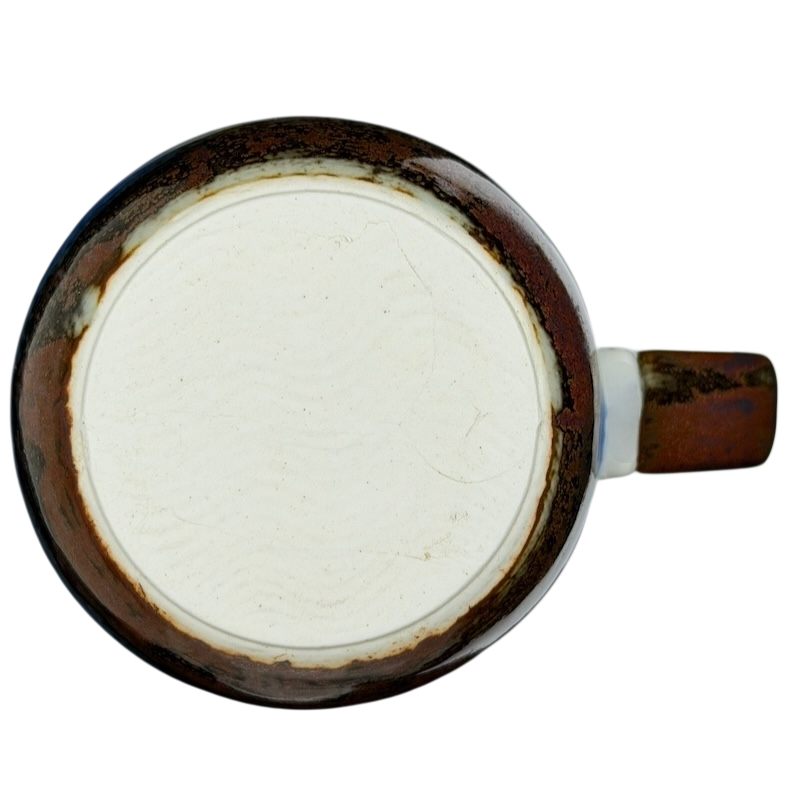 Bottom view of an Otagiri mallard ducks vintage tankard mug showcasing its unique ceramic finish