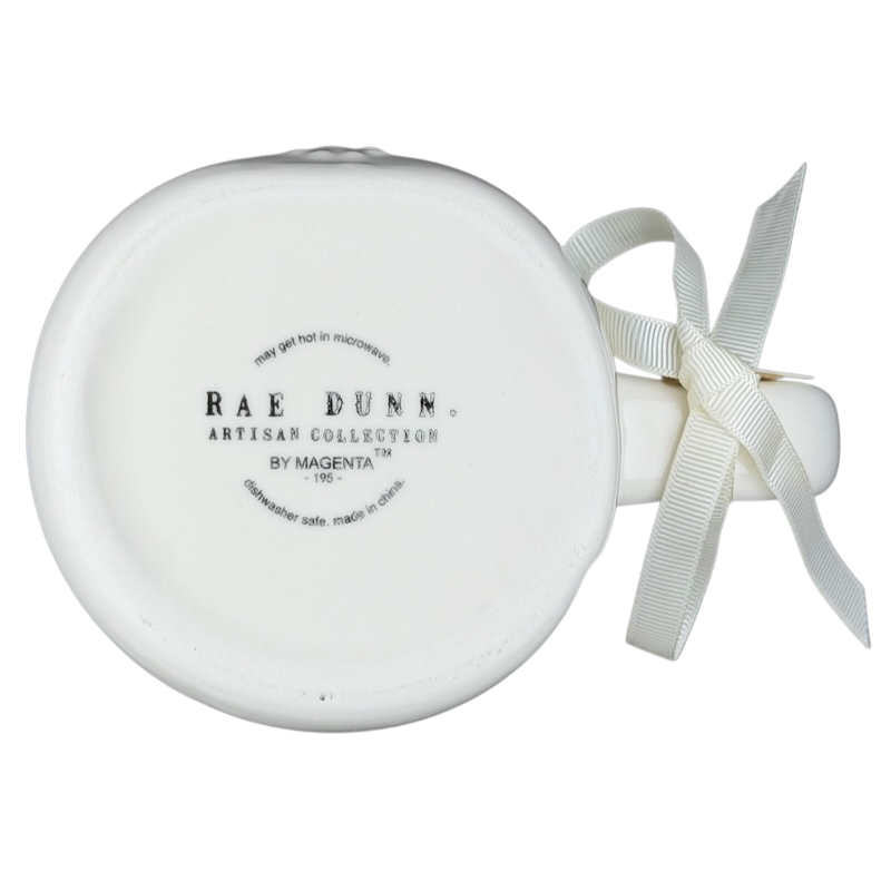 Bottom view of Rae Dunn Merry and Bright collectible mug with decorative ribbon and logo