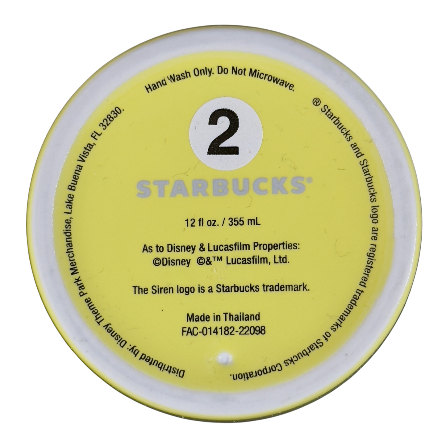 Bottom view of Disneyland Minnie Mouse Starbucks tumbler showing size and care instructions in yellow base