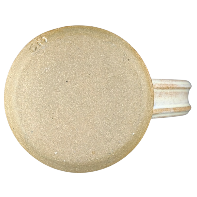 Bottom view of a studio pottery jumbo swirled mug showcasing a textured design and sturdy handle