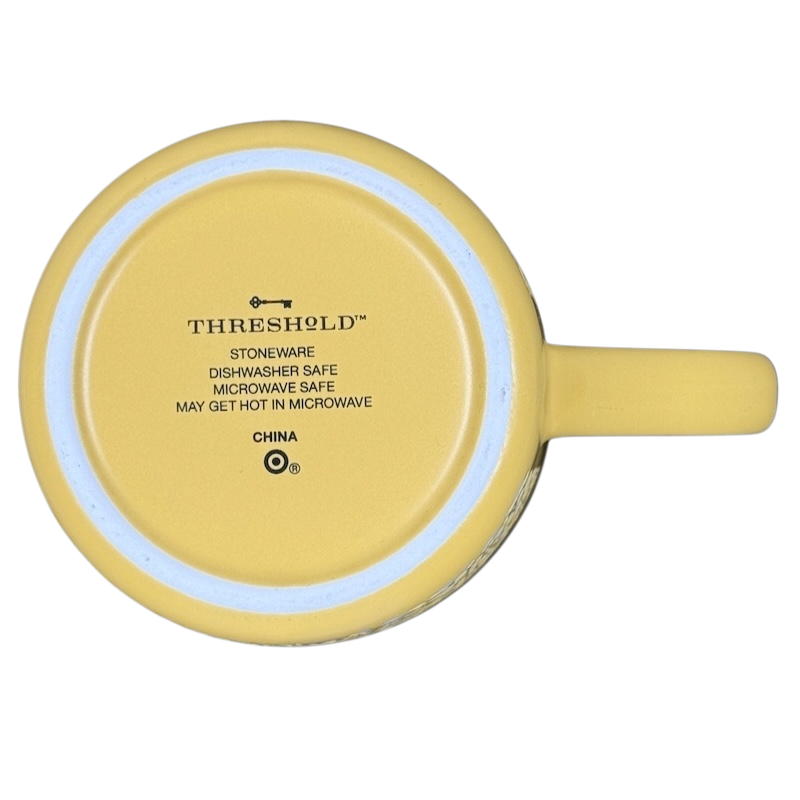 Bottom view of Mornin' Sunshine etched floral Threshold mug yellow stoneware showing logo and care instructions