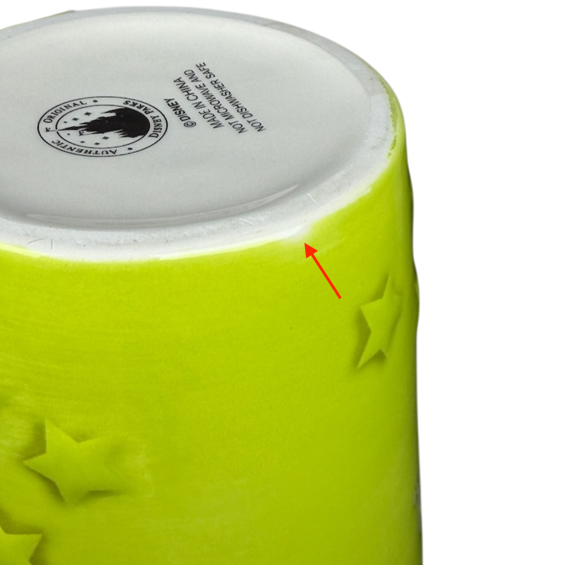 Bottom view of the Tinker Bell Disneyland Resort figural handle mug showcasing the star pattern and vibrant color