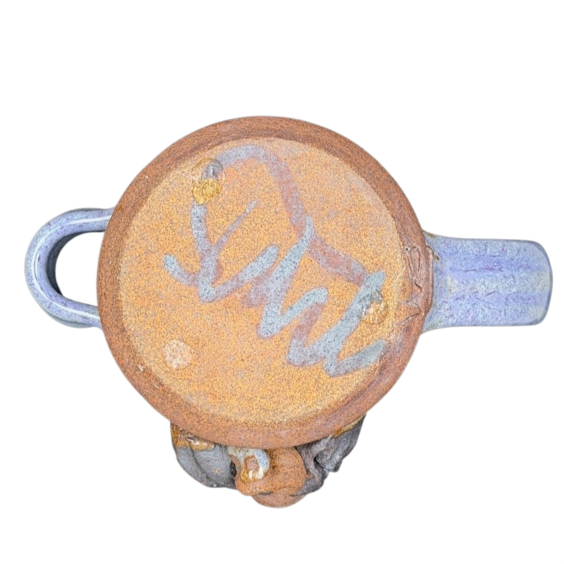 Bottom view of Ugly Face Pottery Man With Moustache And Tongue Mug Mahon Made Stoneware showcasing unique design and texture