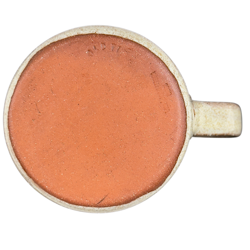 Bottom view of a vintage blue flower mug by Old Time Pottery showcasing its unique clay texture