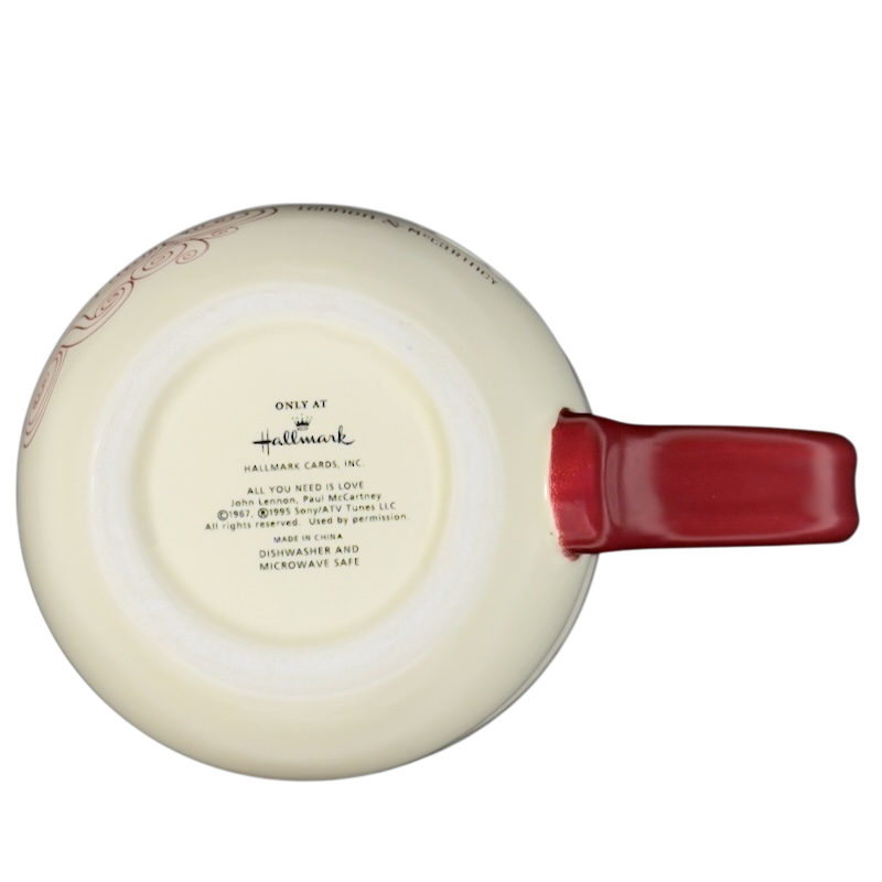 Bottom view of a vintage Lennon McCartney mug featuring a red handle and Hallmark branding