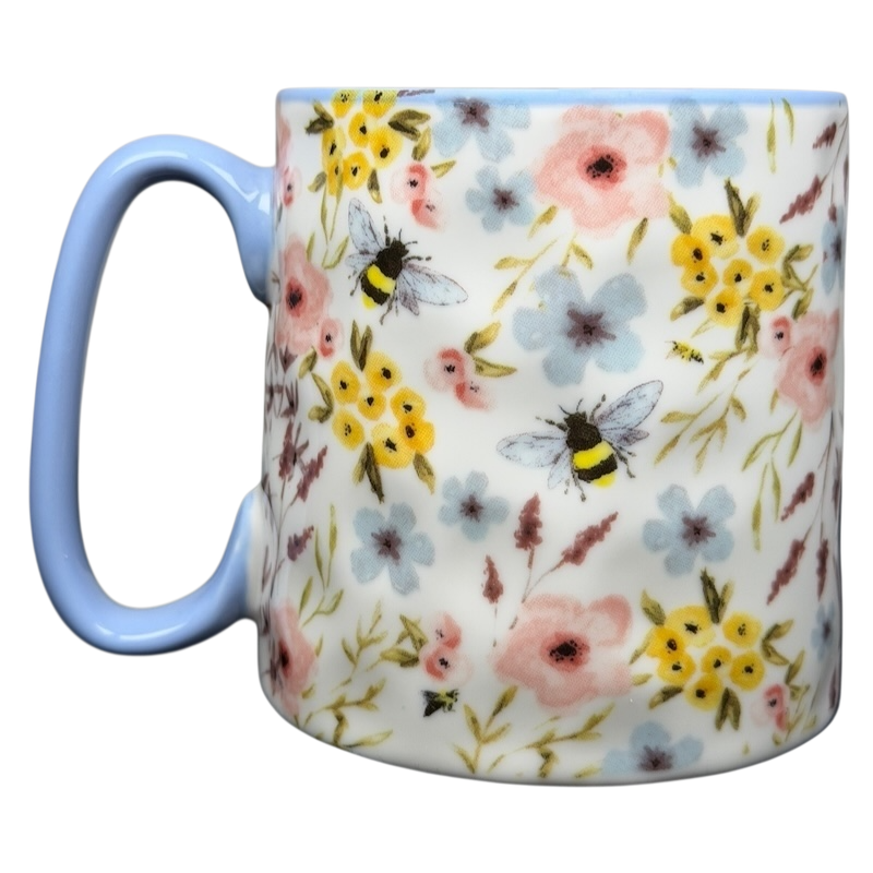 10 Strawberry Street bumblebee wildflowers mug featuring colorful floral designs and a blue handle