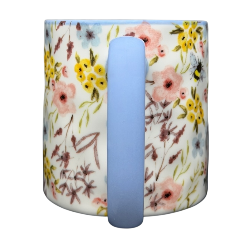 10 Strawberry Street bumblebee wildflowers mug featuring a floral design with pastel colors and a blue handle