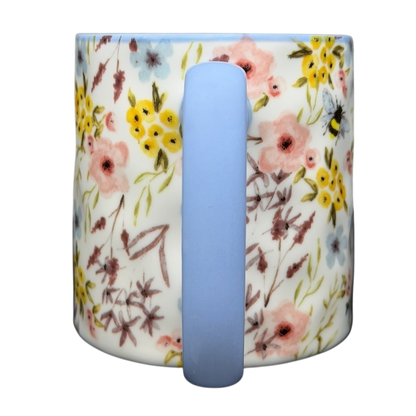 10 Strawberry Street bumblebee wildflowers mug featuring a floral design with pastel colors and a blue handle
