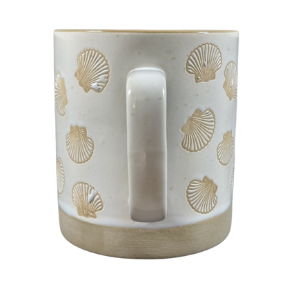 White ceramic sea shell under the sea coffee mug with embossed seashell designs and a smooth handle
