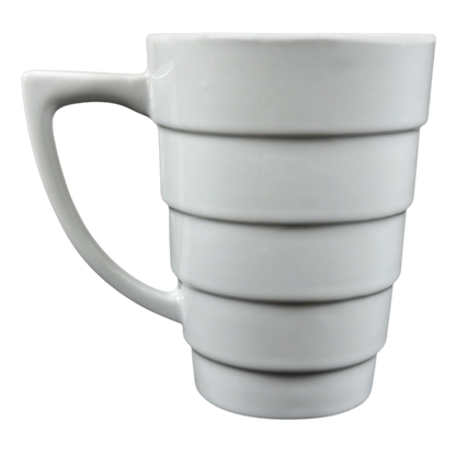 White ceramic Frank Lloyd Wright vintage Guggenheim mug with stepped spiral bands and ergonomic handle
