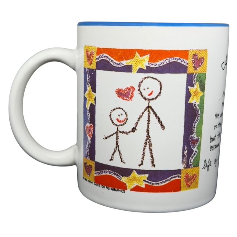 A Hundred Years From Now mug featuring a colorful design with stick figures and hearts