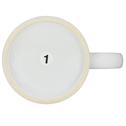 Top view of a white ceramic A Hundred Years From Now mug with a minimalist design and number one detail