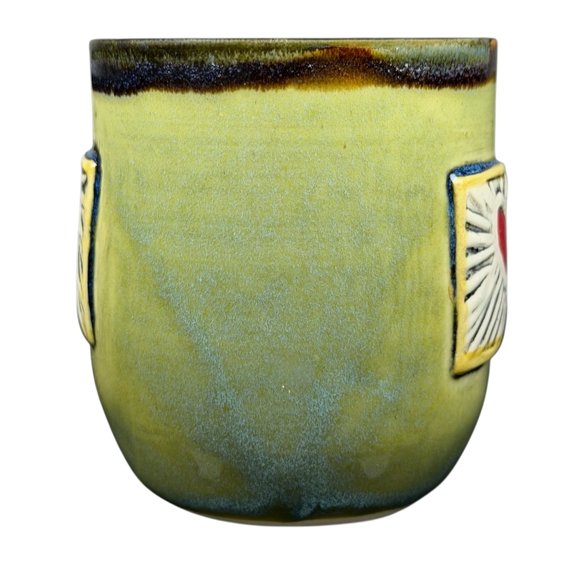 Alissa Clark Clayworks heart mug in vibrant green with decorative heart design on the sides