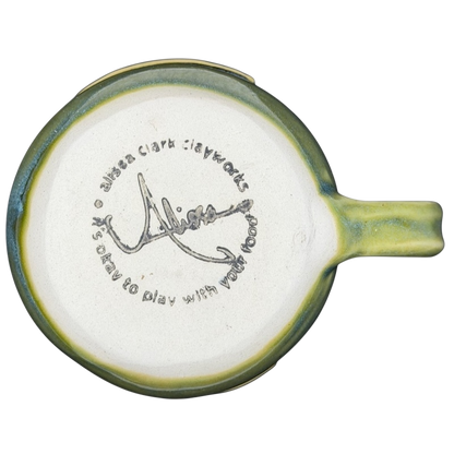 Bottom view of Alissa Clark Clayworks heart mug showcasing unique signature and design details