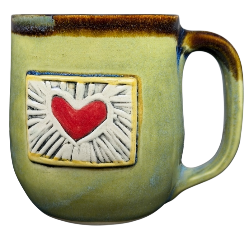 Handcrafted Alissa Clark Clayworks heart mug in green with a red heart design for coffee lovers