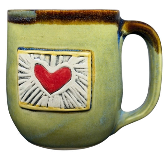 Handcrafted Alissa Clark Clayworks heart mug in green with a red heart design for coffee lovers