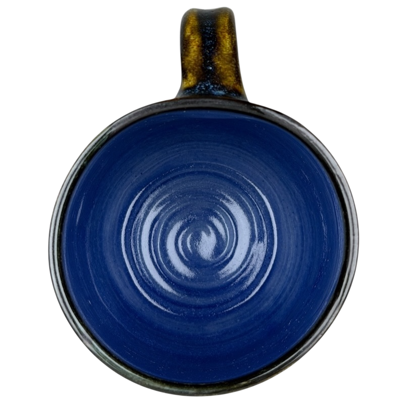Top view of Alissa Clark Clayworks heart mug with a deep blue glossy finish and unique swirl design