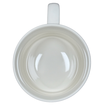 Top view of white ceramic Alexandre Dumas G monogram initial mug empty with handle on black background