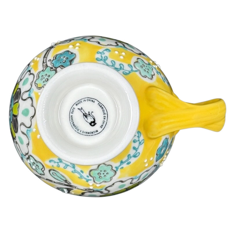 Anthropologie Elka Ayaka floral pedestal mug top view yellow ceramic mug with turquoise floral pattern and pedestal base