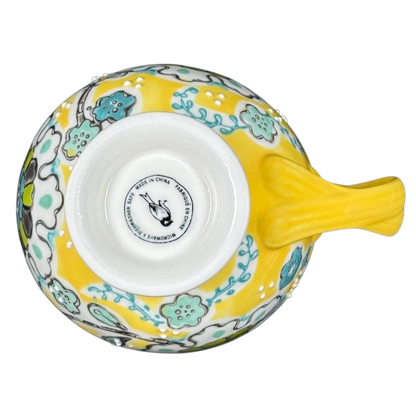 Anthropologie Elka Ayaka floral pedestal mug top view yellow ceramic mug with turquoise floral pattern and pedestal base