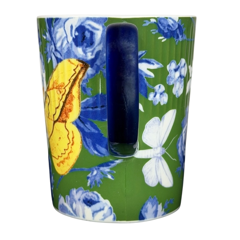 Athalia Butterfly Floral Mug Anthropologie in vibrant green with blue floral patterns and a yellow butterfly