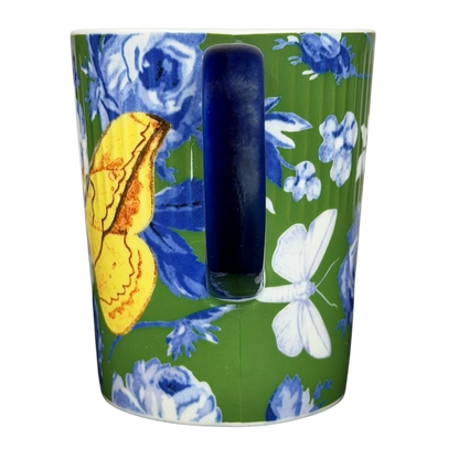 Athalia Butterfly Floral Mug Anthropologie in vibrant green with blue floral patterns and a yellow butterfly