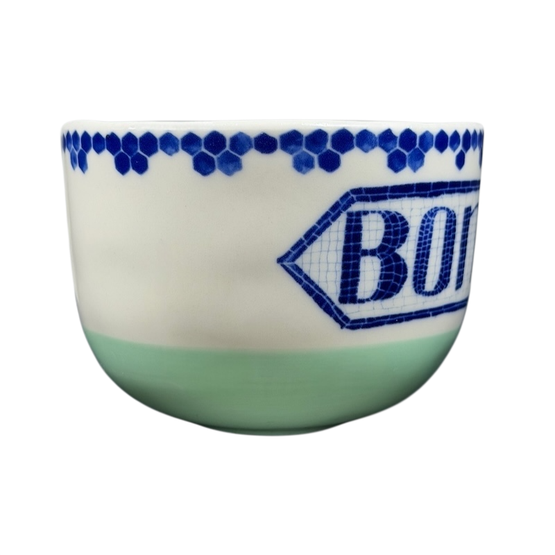 Bonjour Pottery Bistro Mug Anthropologie with decorative blue patterns and green base for stylish coffee enjoyment