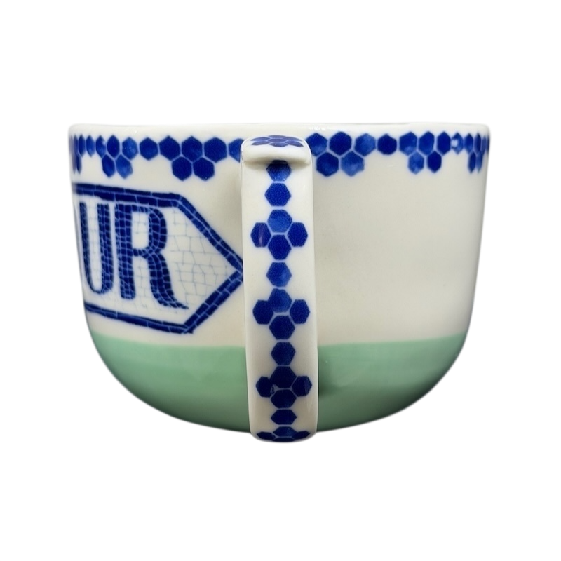 Bonjour Pottery Bistro Mug Anthropologie with a blue pattern and a handle on the side
