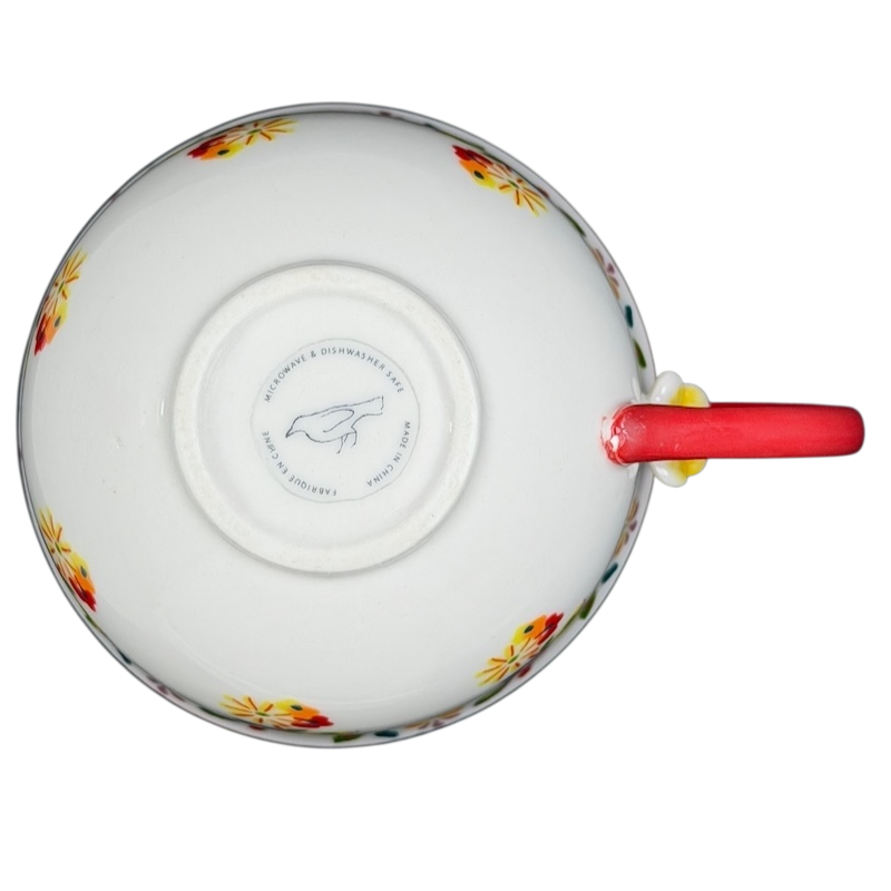 Top view of Cadiz Floral Mug Anthropologie showcasing vibrant floral design and red handle