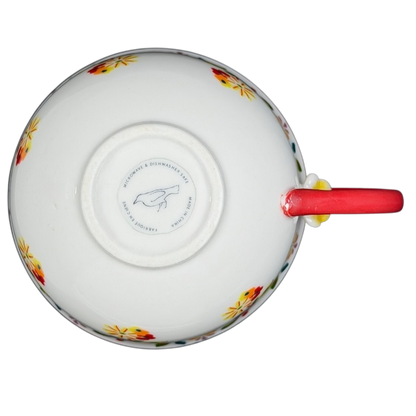 Top view of Cadiz Floral Mug Anthropologie showcasing vibrant floral design and red handle