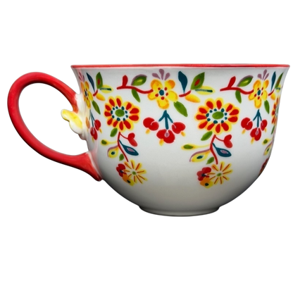 Cadiz Floral Mug Anthropologie featuring vibrant floral patterns and a red handle for colorful dining