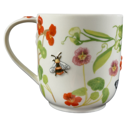 Collectible monogram mug Anthropologie featuring vibrant floral designs and a detailed bee embellishment