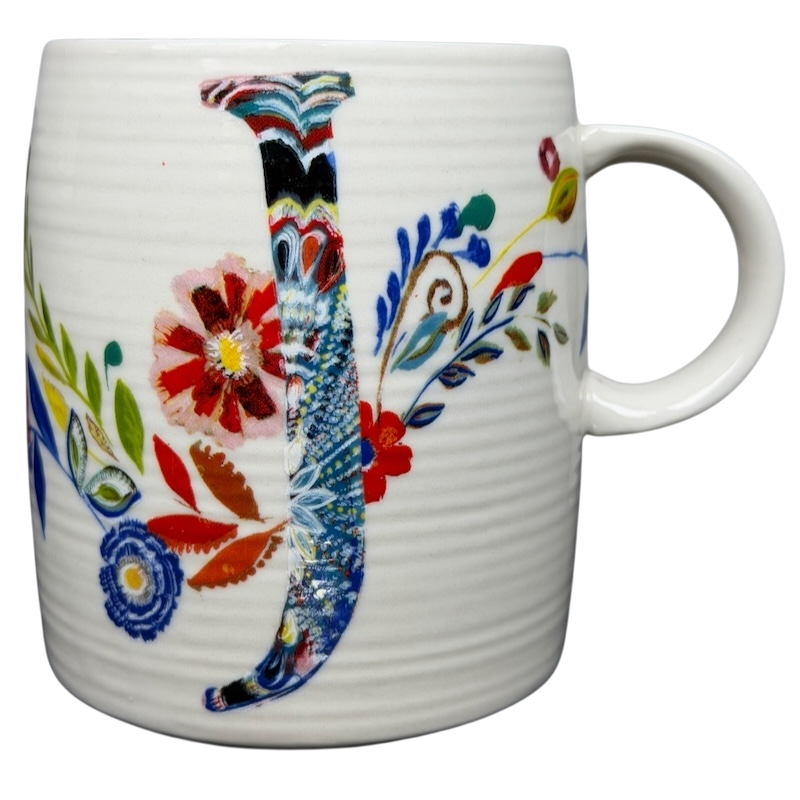 Anthropologie J monogram Starla Halfmann mug decorated with colorful floral designs