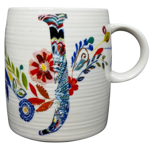 Anthropologie J monogram Starla Halfmann mug decorated with colorful floral designs