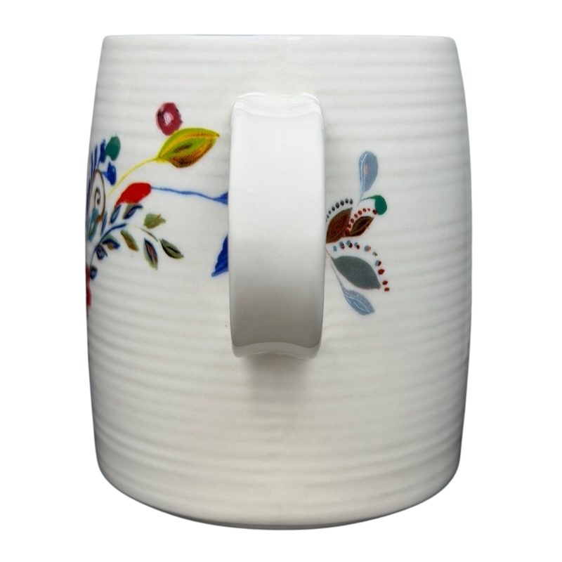 Anthropologie J monogram Starla Halfmann mug with colorful floral design and a comfortable handle