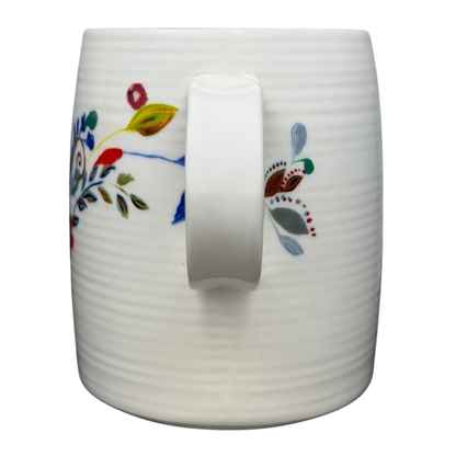 Anthropologie J monogram Starla Halfmann mug with colorful floral design and a comfortable handle