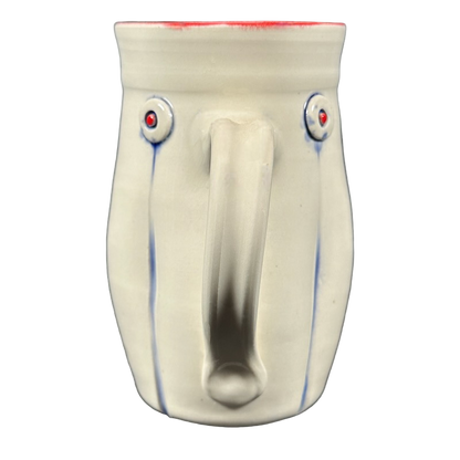 Rebecca Lowery embossed pottery mug front view cream ceramic mug with red rim and blue vertical accents