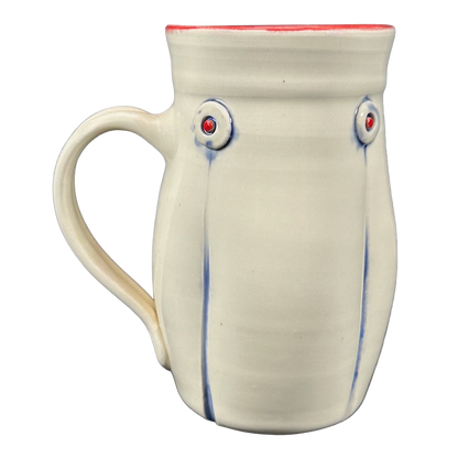 Rebecca Lowery embossed pottery mug cream wheel thrown mug with blue drip accents red rim and round embossed dots