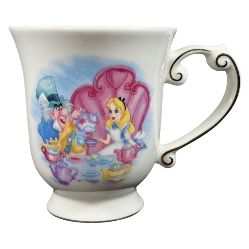 Disney Alice in Wonderland Mad Hatter vintage mug showing Mad Hatter and Alice tea party on white porcelain with ornate handle