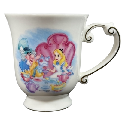 Disney Alice in Wonderland Mad Hatter vintage mug showing Mad Hatter and Alice tea party on white porcelain with ornate handle