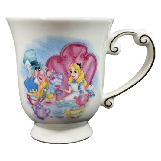 Disney Alice in Wonderland Mad Hatter vintage mug showing Mad Hatter and Alice tea party on white porcelain with ornate handle