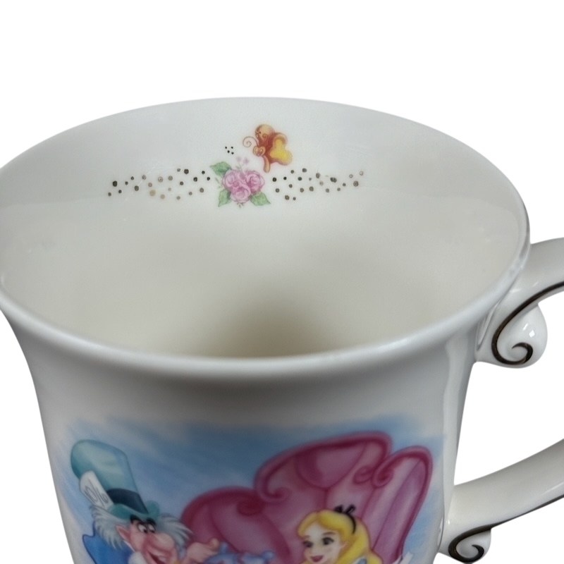 White porcelain Disney Alice in Wonderland Mad Hatter vintage mug featuring Alice and Mad Hatter illustration and floral gold rim