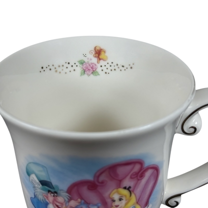 White porcelain Disney Alice in Wonderland Mad Hatter vintage mug featuring Alice and Mad Hatter illustration and floral gold rim