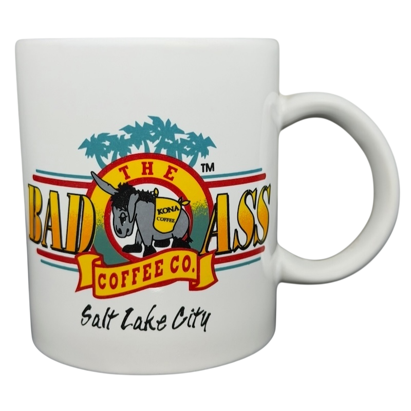 Bad Ass Coffee Company Salt Lake City mug featuring colorful logo and palm tree design