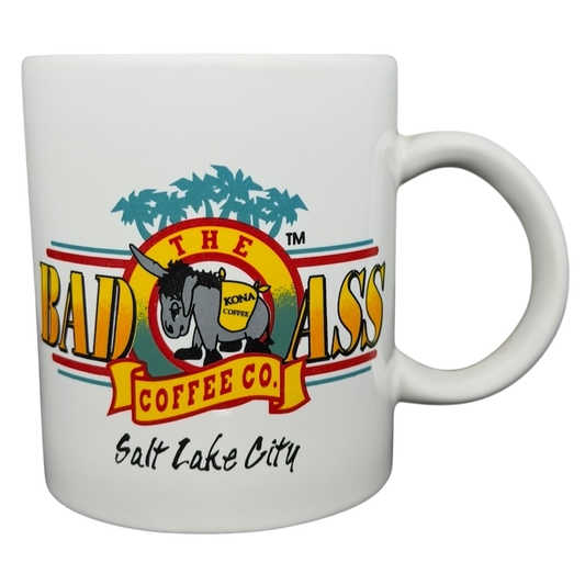 Bad Ass Coffee Company Salt Lake City mug featuring colorful logo and palm tree design