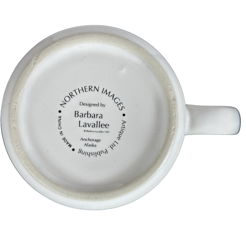Bottom view of Barbara Lavallee Inuit family sledding mug showing design details and branding